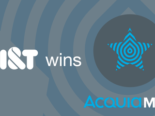 A grey background with the saying Acquia Partner of the Year 2017