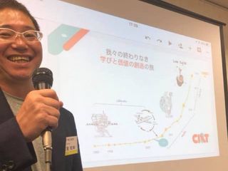 Asian man smiling and holding a microphone