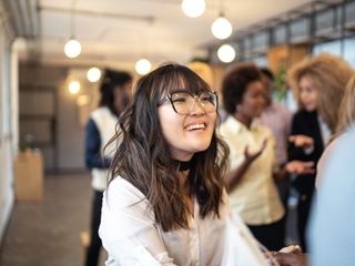 Asian woman with glasses smiling
