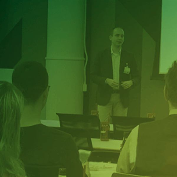 CI&T executive Lucas Persona speaking with a green light effect on the image