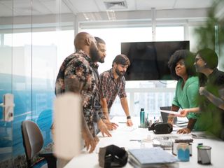 Diverse business team discussing plans during business meeting