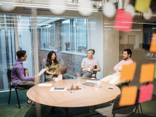 Group of people sitting around a table discussing