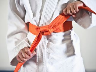 Kid tightening karate belt