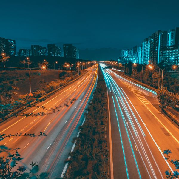 Light trails along a busy highway in perspective at night