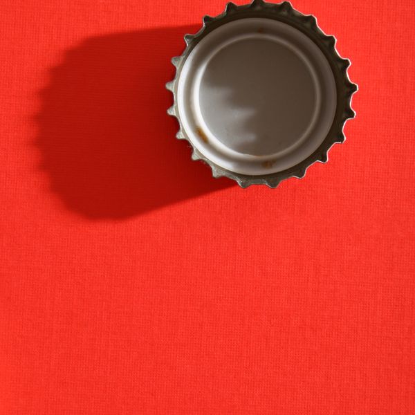 Straight down shot of bottle cap in red background