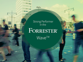 Strong Performer in the Forrester Wave badge with a picture of people walking on the street in the background