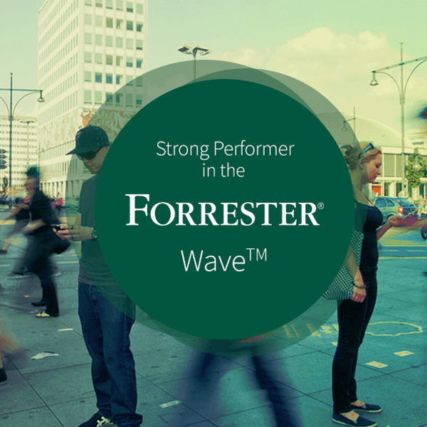Strong Performer in the Forrester Wave badge with a picture of people walking on the street in the background