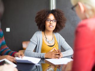 Woman discussing with her colleagues during a meeting