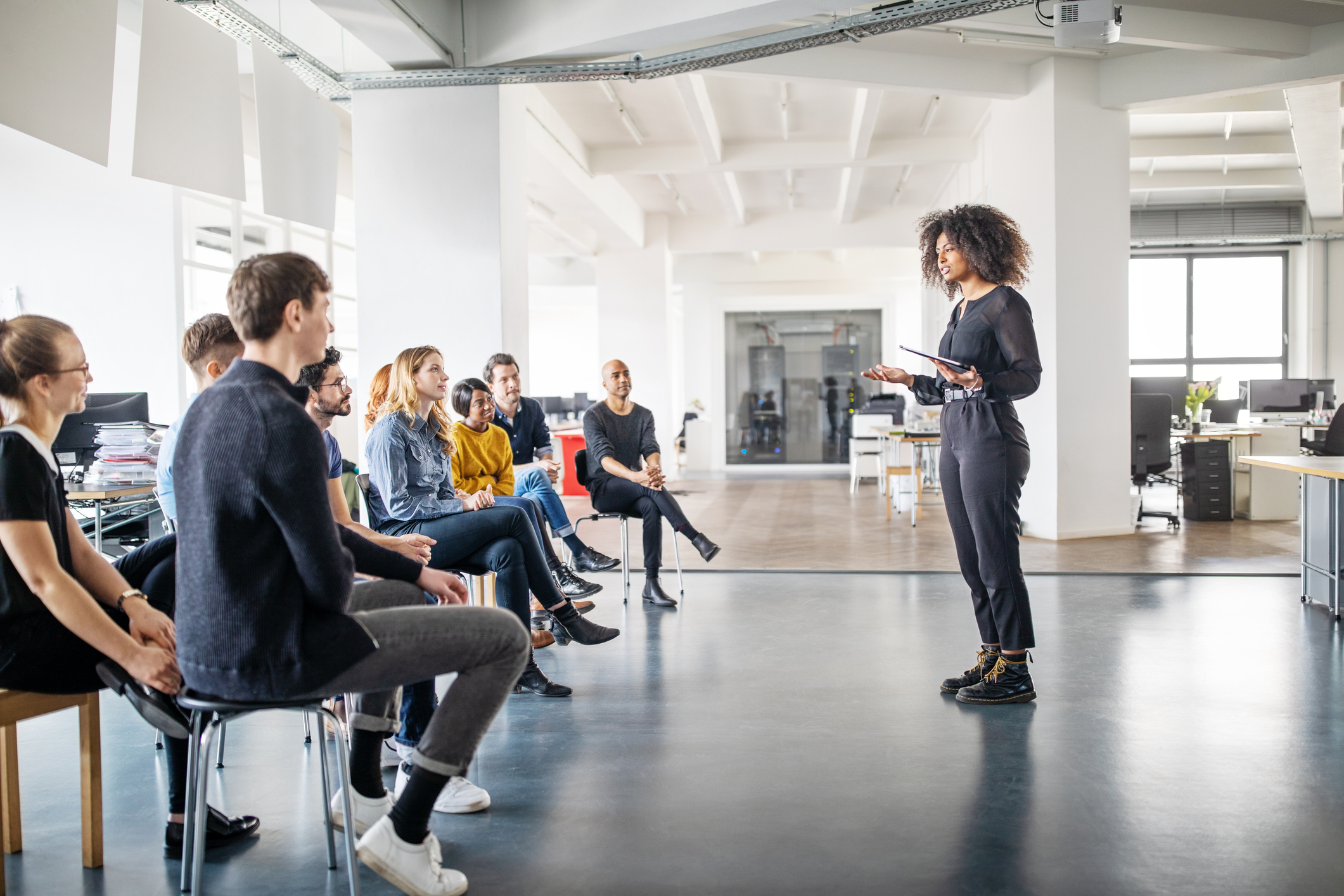Woman sharing her views with team in office meeting