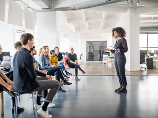 Woman sharing her views with team in office meeting