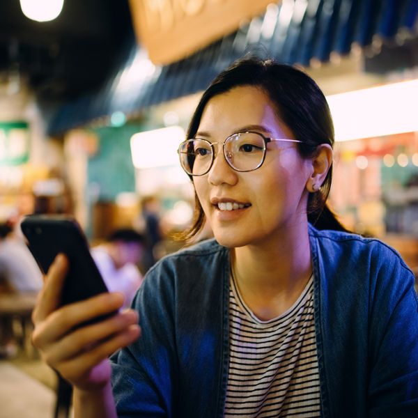 Woman using smartphone in a traditional style restaurant