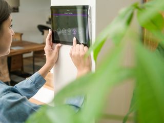 Woman with tablet with smart home control functions