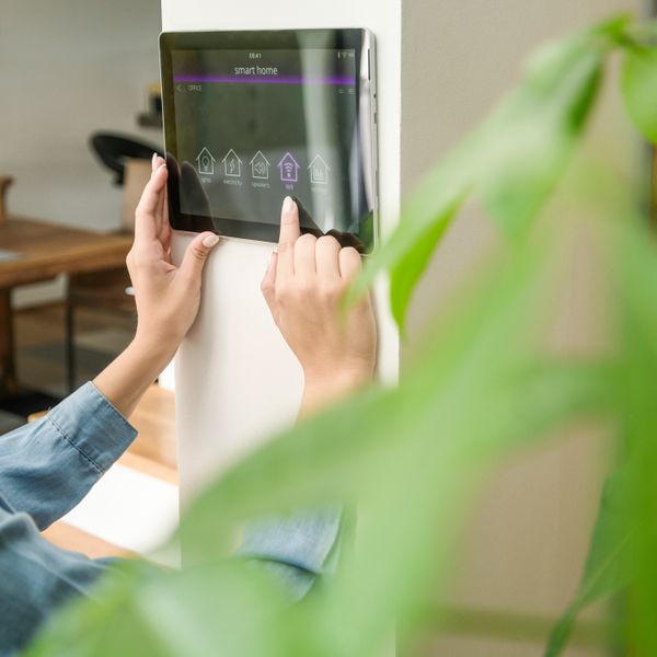 Woman with tablet with smart home control functions