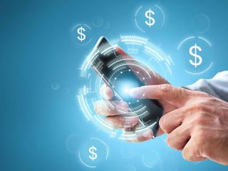 Close up of a hand holding a smartphone with dollars sign popping out of it