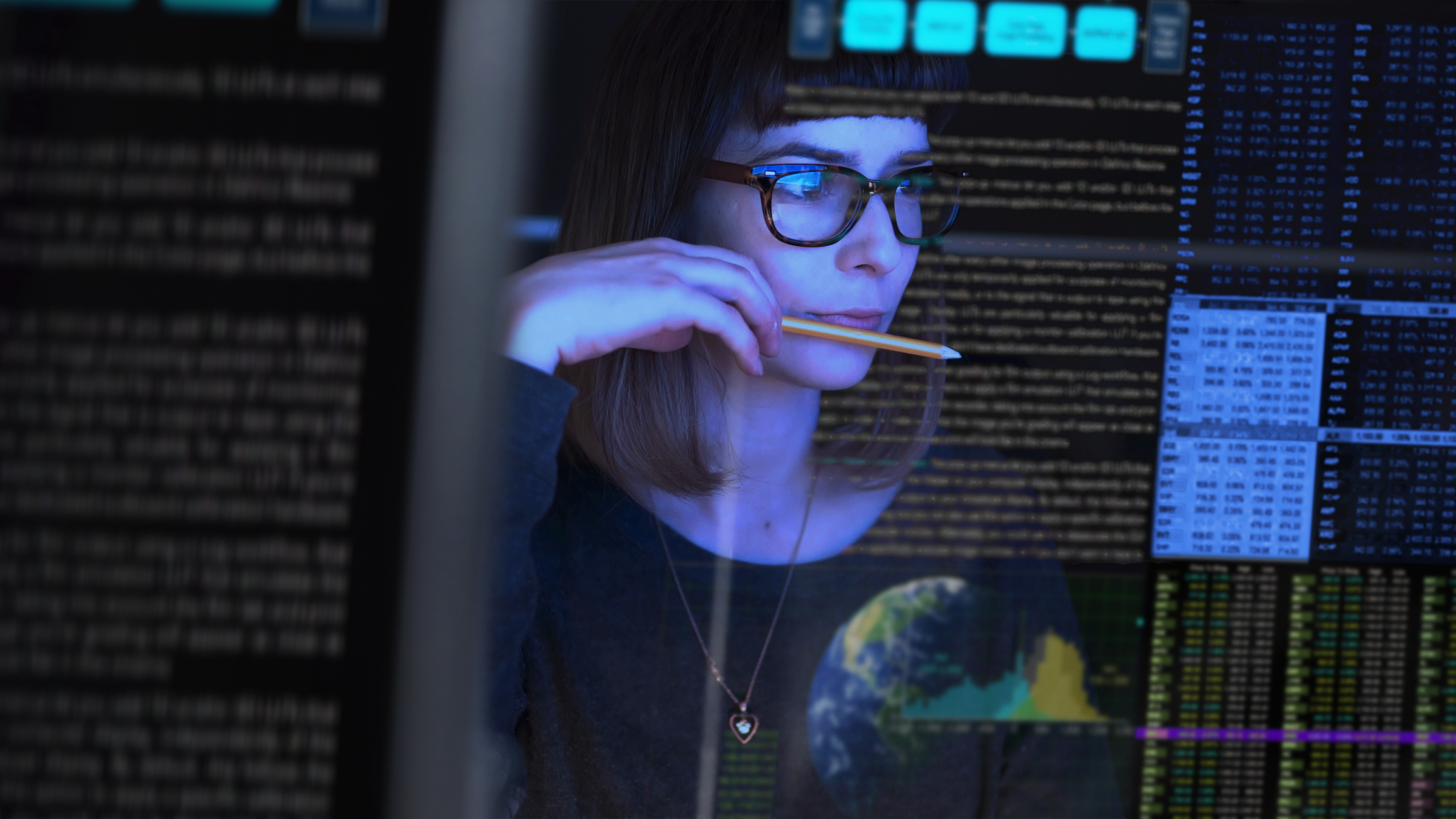 Woman holding a pencil with codes reflected on her