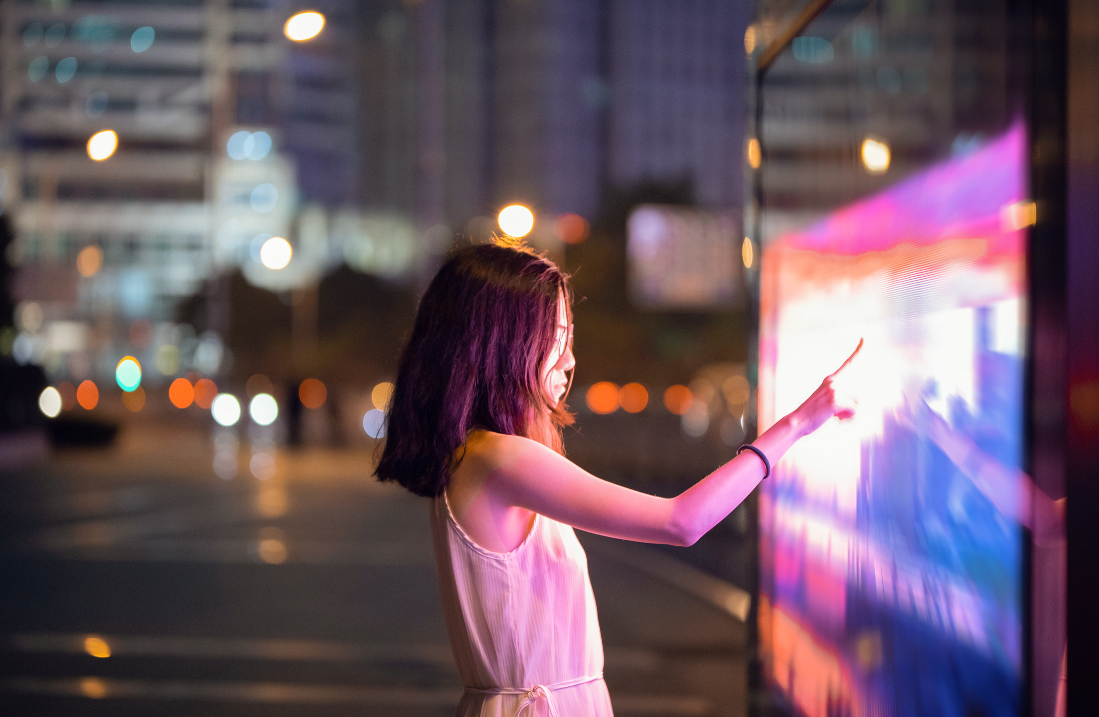 Woman touching colored screen