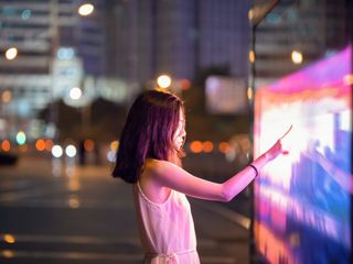Woman touching colored screen