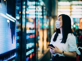 a woman looking at a chart on the wall