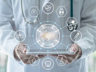 a doctor holding a tablet with digital icons