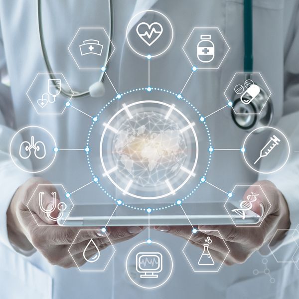 a doctor holding a tablet with digital icons