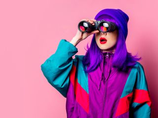  woman using a binoculars showing curiosity