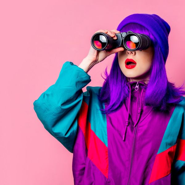  woman using a binoculars showing curiosity