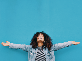Young Woman standing with her arms outstretched 