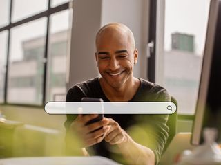 man using phone searching on internet