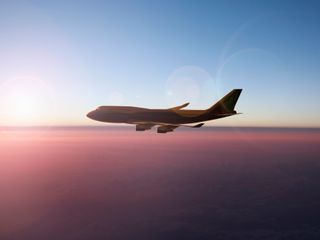 Airplane flying on sunset