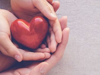 Hands holding a heart shaped object