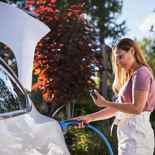 Woman charging electric car