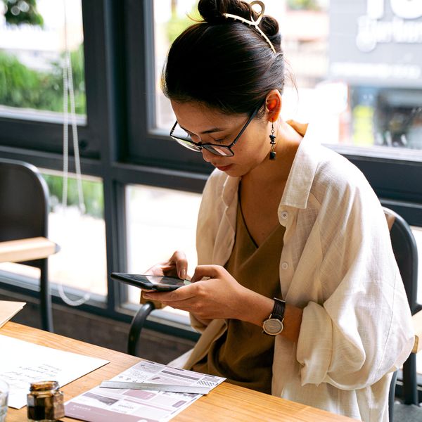 Woman sitting and holding a smartphone