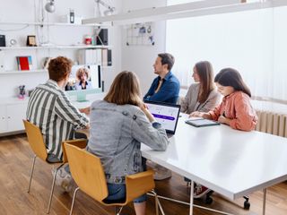 Group of young coworkers attending a video conference at the office