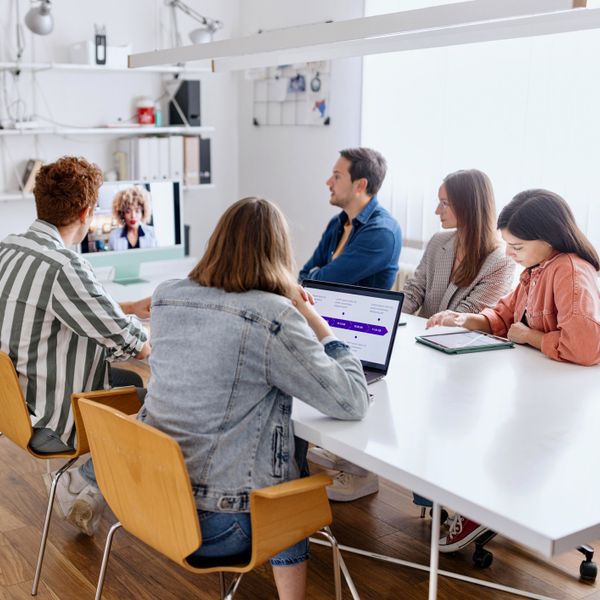 Group of young coworkers attending a video conference at the office