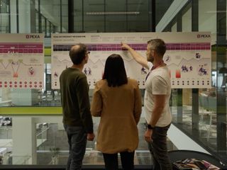 A team of two men and one woman looking at a customer journey board