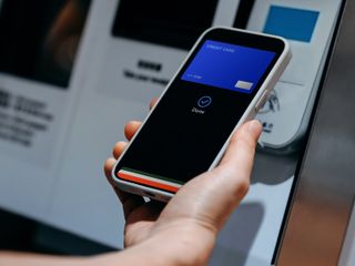 hand paying bill through smartphone nfc technology
