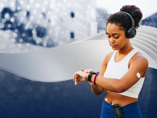Young woman stopping her exercise to check her health via wearable devices 