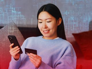 Woman making digital payment through smartphone from the comfort of her home