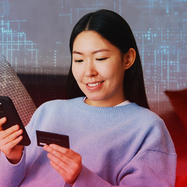 Woman making digital payment through smartphone from the comfort of her home