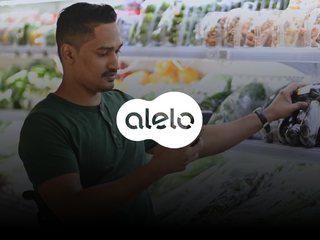 man in a wheelchair choosing vegetables at the supermarket