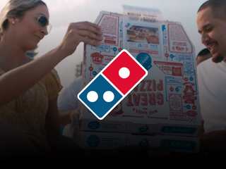 A woman and a man sharing a Dominos pizza