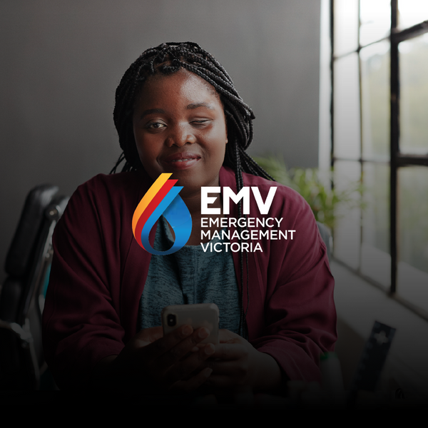 Visually impaired black woman holding phone and looking at the camera smiling