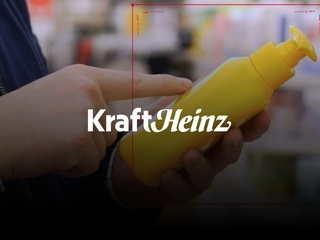 Person holding a bottle of mustard at the supermarket