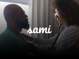 Black woman doctor hearing a black mans heart through a stethoscope