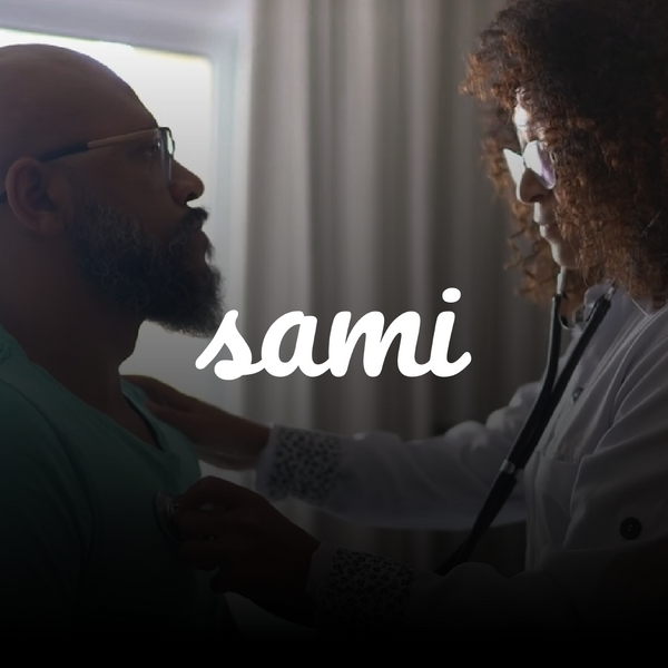 Black woman doctor hearing a black mans heart through a stethoscope