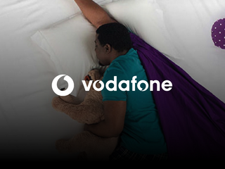 Black man sleeping holding a stuffed animal 