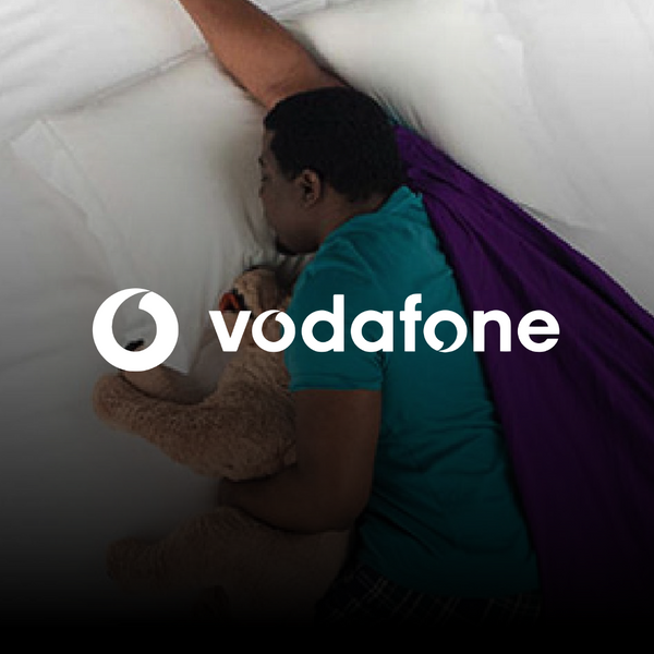 Black man sleeping holding a stuffed animal 