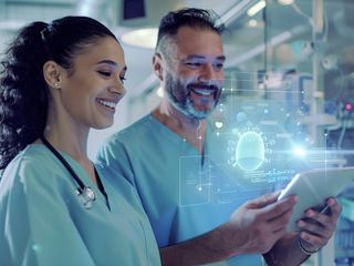 Two doctors looking at data on digital tablet