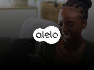 Alelo logo at the front of the image, and a black girl using her phone on the background.