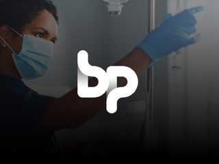 BP logo at the front of the image, and a black woman working at a hospital